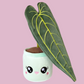 Plush toy of a potted plant with a green pot. The plush toy represents a Queen Anthurium plant with a deep green leaf. The leaf has a heart-shaped design. The pot features a cute, open-mouthed smiling face. The plush toy is soft and huggable, designed to resemble the beauty of a Queen Anthurium plant in a lovable and playful form.