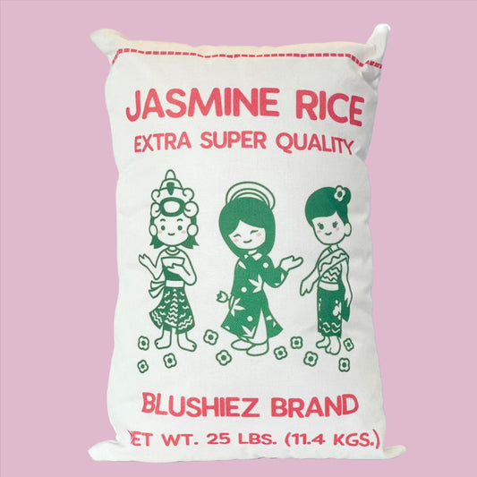 Pillow inspired by Jasmine Rice packaging, featuring a kawaii-style illustration of three girls in dresses colored in green.. The white background creates a vibrant contrast, with 'Jasmine Rice' text in red and a dotted line resembling the bag's stitching. Playful and culturally inspired artwork.