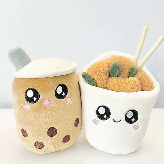 Plush toys of a boba drink and popcorn chicken characters, joined together with magnets. The boba drink character has a cute smiling face, and the popcorn chicken character also has a cheerful expression.